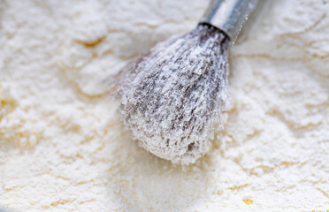 The texture of natural fibers, artist's brush bristles with a metal ferrule sprinkled with white powdery substance