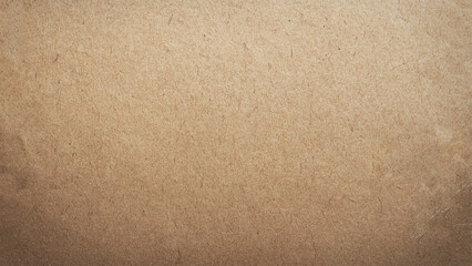 Brown paper or cardboard texture background. Grainy brown paper with dark border.
