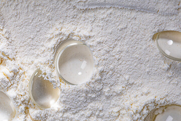 White wheat flour with round crystals embedded inside it and visible on the surface