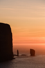 Majestic Risin og Kellingin at sunset in the Faroe Islands capturing natures beauty