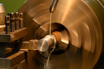 The lathe machine finish cut metal shaft parts with liquid coolant method.