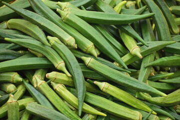  Green okra for sale on a market stall.