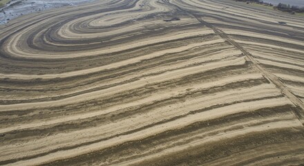 Aerial view of layered earth with concentric patterns and a path cutting through the landscape texture - ia generated