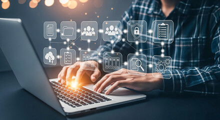 Man typing on laptop with digital network of business icons overlayed