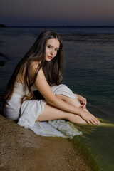 Beautiful woman sitting in the sea water