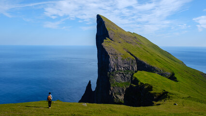 Discovering the breathtaking cliffs of the Faroe Islands under a clear blue sky