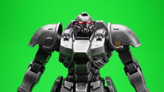 Futuristic mecha soldier in heavy power armor with glowing red eyes on a green screen background