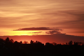 The sky is orange and the sun is setting