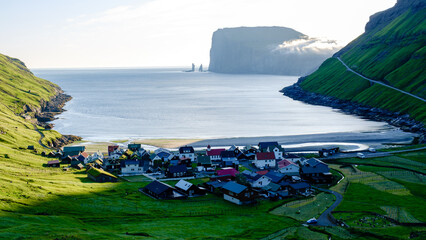 Serene village nestled in the lush landscapes of the Faroe Islands at sunrise