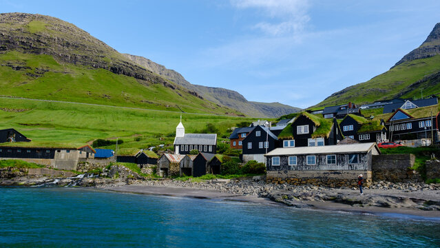 Scenic view of traditional houses and church in the coastal village of Saksun, Faroe Islands
