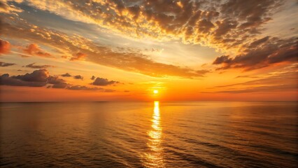 Beautiful orange sunset over calm ocean horizon
