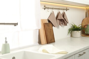 Clean waffle towels hanging on hook rack in kitchen