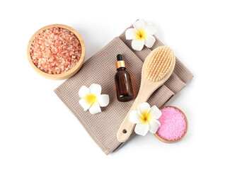 Fototapeta na wymiar Clean waffle towels, plumeria flowers and spa products isolated on white, top view