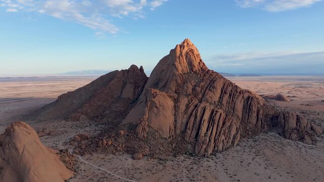 Aerial view of majestic rock formations in a vast desert landscape, Spizklopp, Erongo, Namibia.