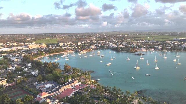 Aerial view of beautiful tropical bay with yachts and boats along the serene coastline, Grand Baie, Riviere du Rempart, Mauritius.