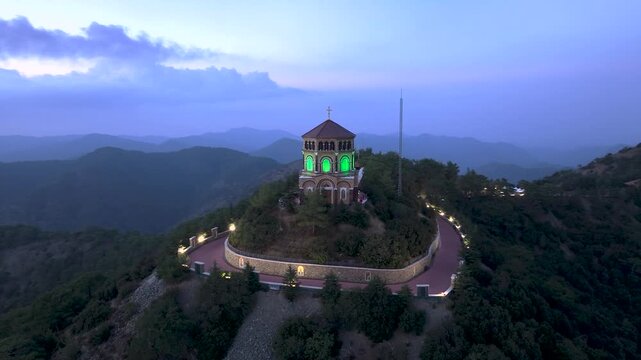 Aerial view of throni church on a hilltop surrounded by serene landscape and majestic mountains, Tsakistra, Nicosia, Cyprus.