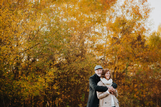 Older couple spending time outdoors in fall season.