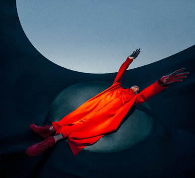Fototapeta Vibrant red fashion pose in abstract setting.