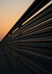 Naklejka premium Abstract Metal Slat Structure at Sunset A Modern Geometric Perspective