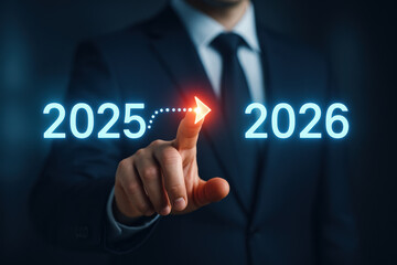 Businessman pointing glowing arrow from 2025 to 2026, symbolizing transition and future progress