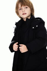 Young boy in stylish black winter coat.