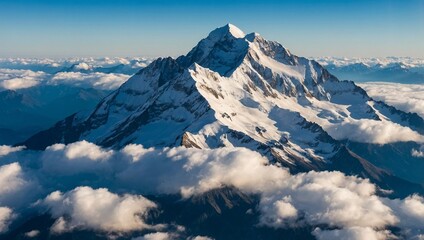 Naklejka premium A scenic panoramic view of a majestic snowy mountain peak. Beautiful mountains covered in winter snow, clear light blue sky with some clouds. Picturesque nature glacier landscape photograph.