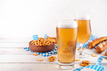Oktoberfest greeting card background with two beer glasses, salted snack and pretzels. Oktoberfest...