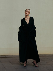 Model in Black Dress Posing Confidently.