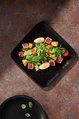 nicoise salad with seared tuna, bright lighting, overhead composition