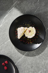 Meringue roulade with pistachio and raspberry, bright lighting, overhead minimal composition