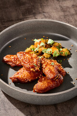 Buffalo chicken wings with eggplant salad, bright natural lighting, overhead composition