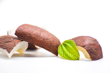 coconut isolated on white background, halved and whole coconut on white table, One whole and two cracked cut