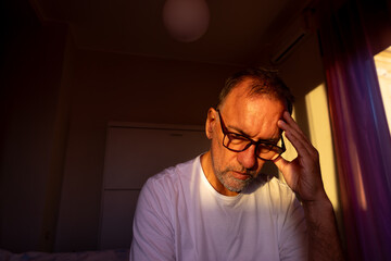 Middle-aged man with glasses in white t-shirt