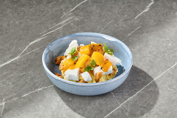 Biscuit dessert with mango, passionfruit, and meringue in bright lighting, overhead composition