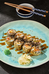 Tempura salmon roll with spicy sauce, bright rustic lighting, overhead composition