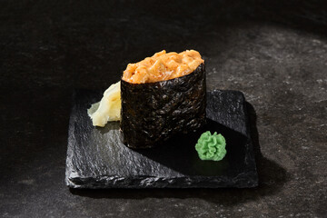 Salmon gunkan sushi on slate, moody lighting, minimal overhead composition