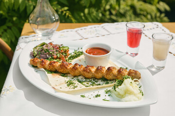 Lyulya kebab with grilled vegetables, bright summer mood, overhead outdoor composition