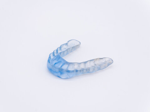 Close-up of a transparent custom-made dental night guard or mouthguard, offering protection against teeth grinding and bruxism