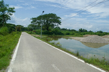 Tranquil Road Scene A Serene Landscape with Sky and Water in a Realistic Photo Style