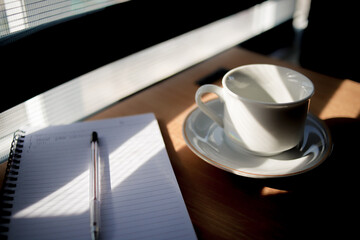 hot cup of coffee on the table in the morning, relaxing time, by the window