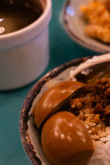 Closed up hard boiled egg in Taiwanese braised pork over rice (lu rou fan)