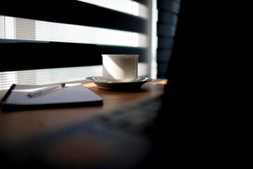 Cup of coffee and laptop on vintage iron table.