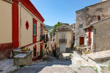 A narrow street among the ancient houses of a medieval village in Abruzzo, Italy.