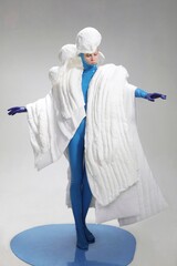 Female model in avant-garde white fashion attire.