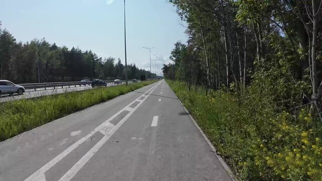 cycling on a bike path outside the city, first-person view, timelapse