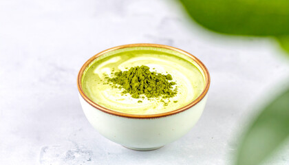 Creamy matcha latte with beautiful latte art in a white cup, isolated on white background, perfect for cafe menus, tea shops, and healthy drink concepts.