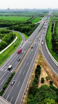 Cinematic 4K aerial footage shot with DJI Mini 4 Pro, capturing a busy multilane expressway, overpasses, and lush green landscapes in high-resolution detail.