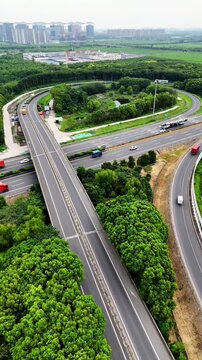 Cinematic 4K aerial footage shot with DJI Mini 4 Pro, capturing a busy multilane expressway, overpasses, and lush green landscapes in high-resolution detail.