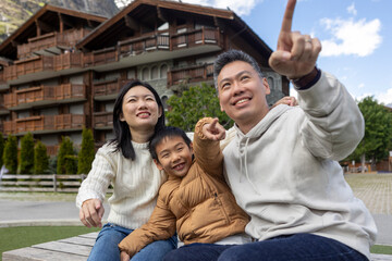 Happy family pointing while sightseeing in zermatt, switzerland