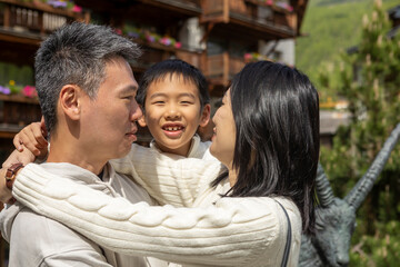 Happy asian family embracing in mountain village